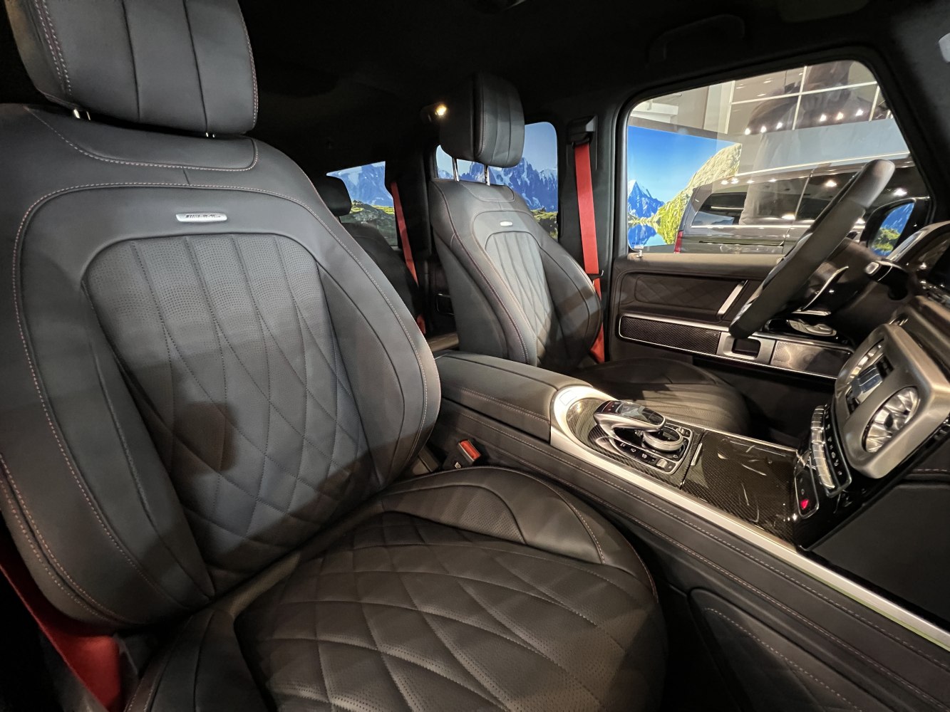 Diamond quilted leather seats with carbon fiber center console and red seat belts