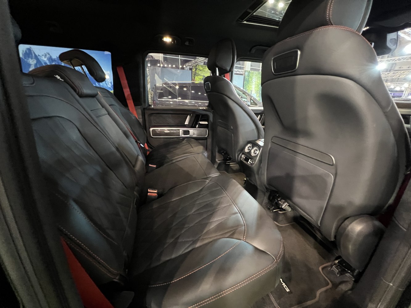 Black leather rear seats with diamond stitching and red seat belts