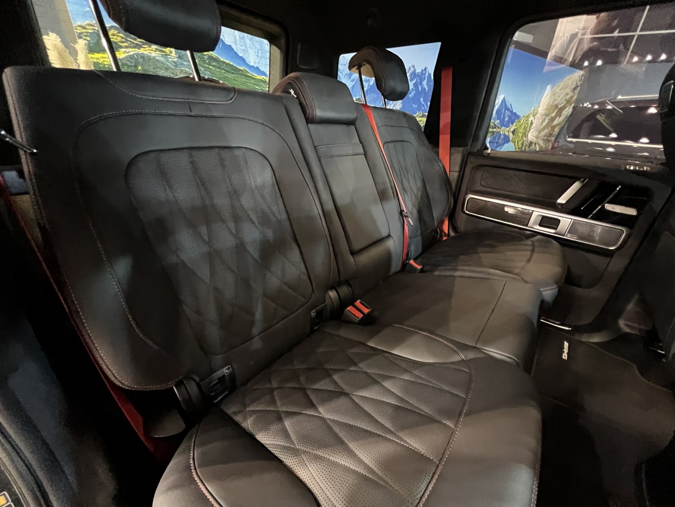 Black leather rear seats with detailed stitching and headrests in spacious SUV cabin