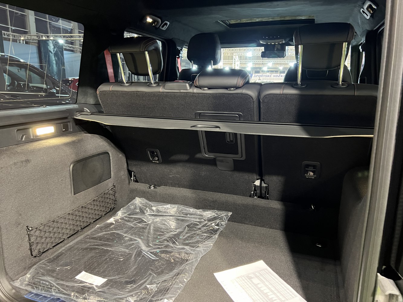 Spacious SUV rear cargo with foldable seats, storage net, and interior lighting