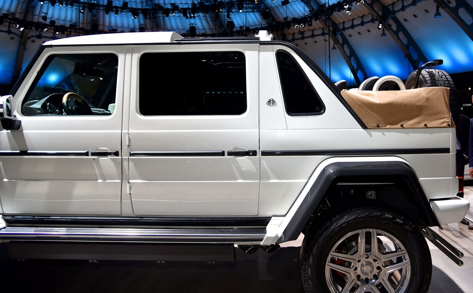 Side profile of luxury SUV with open rear cargo and large wheels