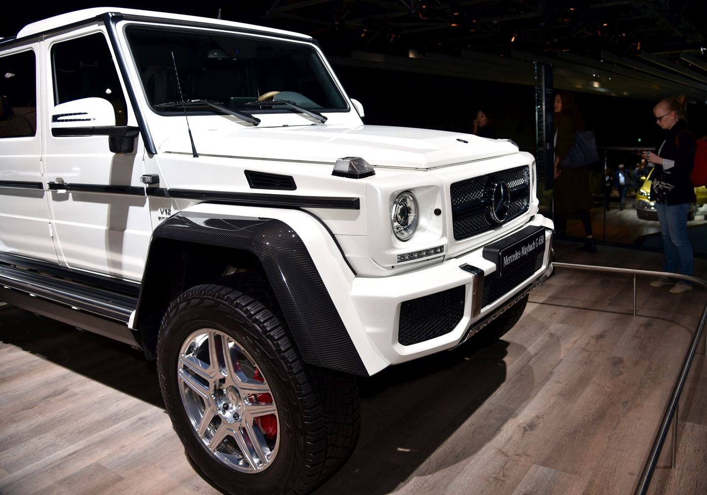 Luxury SUV front with carbon fiber fender flares and round headlights