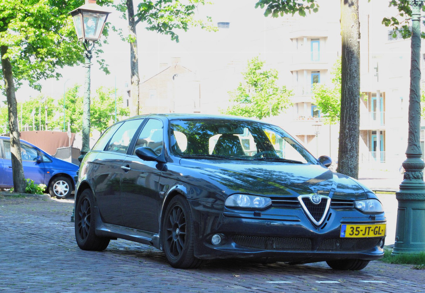 Black sporty wagon with sleek headlights and distinct grille.