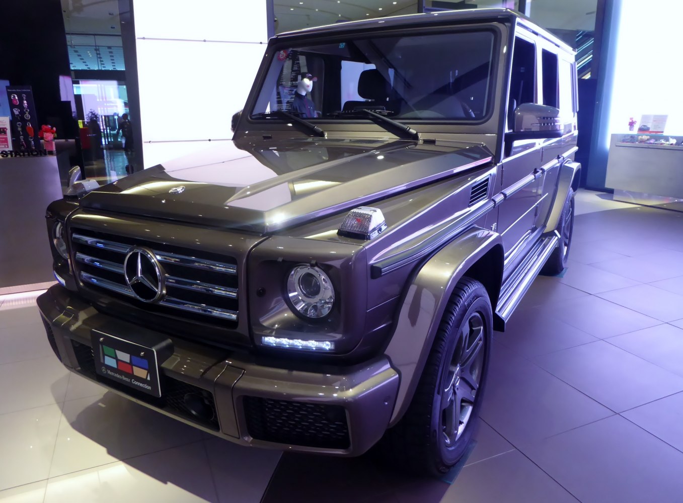 Front grille and headlight of a luxury SUV in showroom lighting