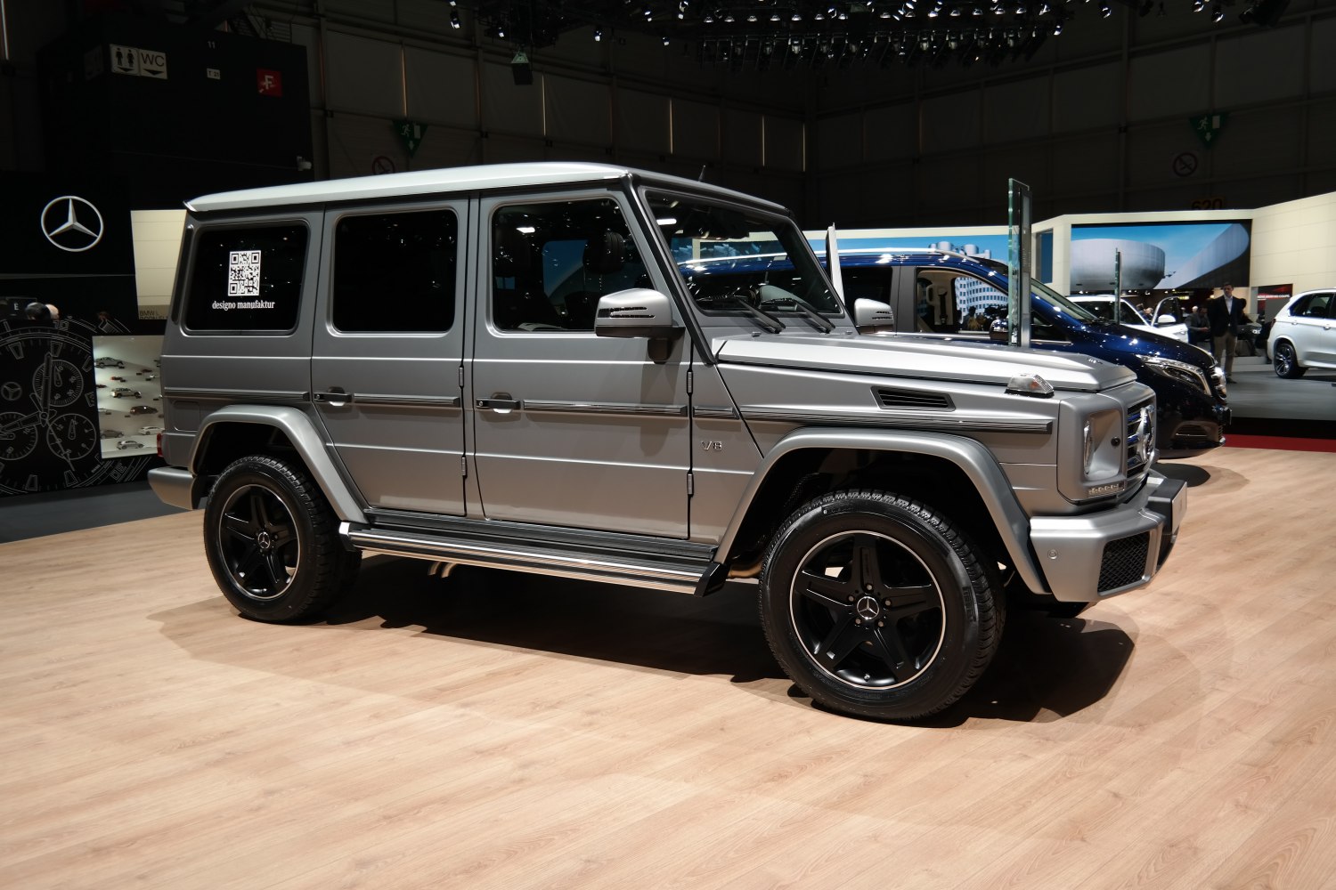 Side view of silver SUV with V8 badge and black five-spoke wheels