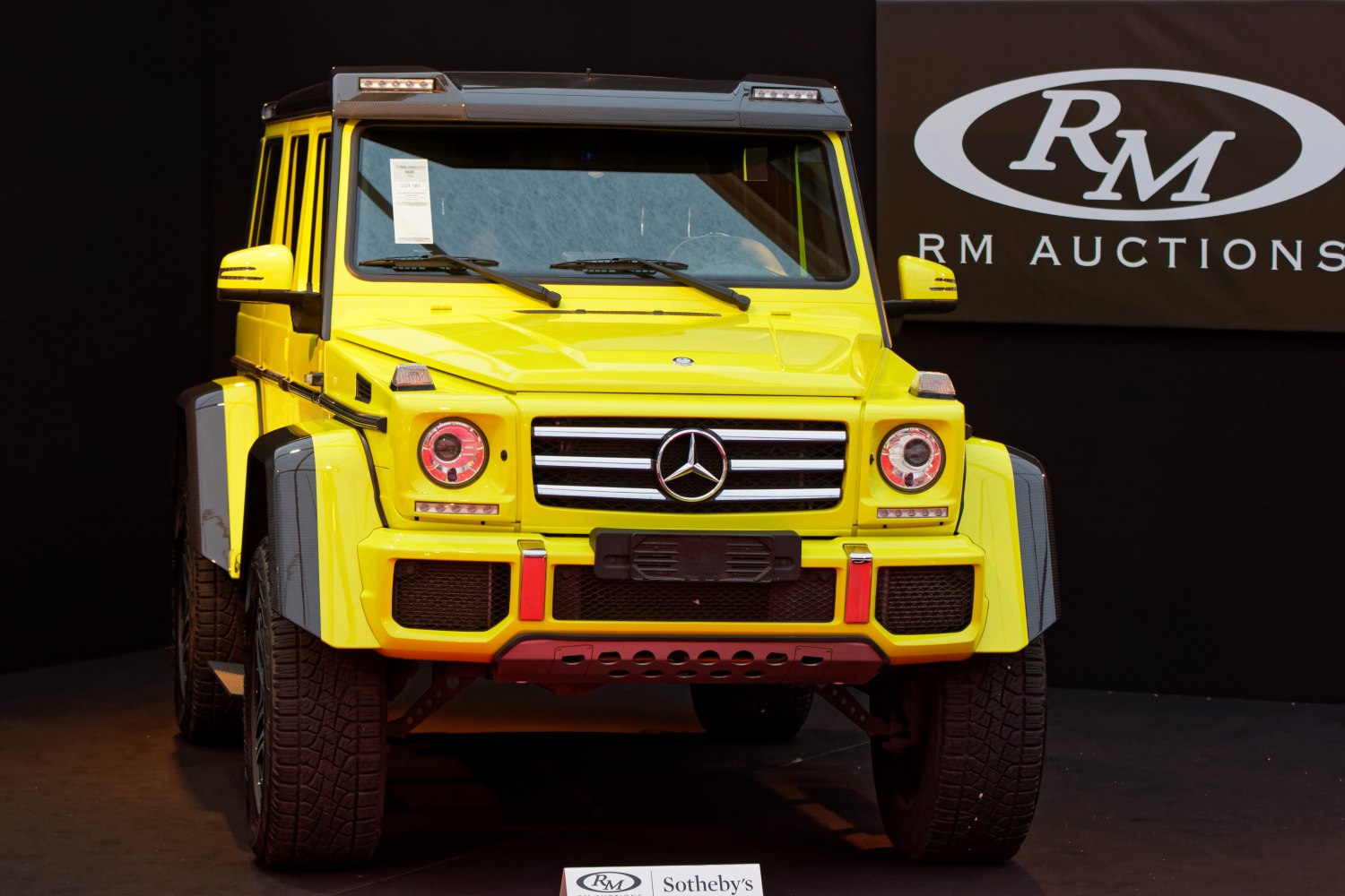 Front view of yellow off-road SUV with LED headlights and robust bumper