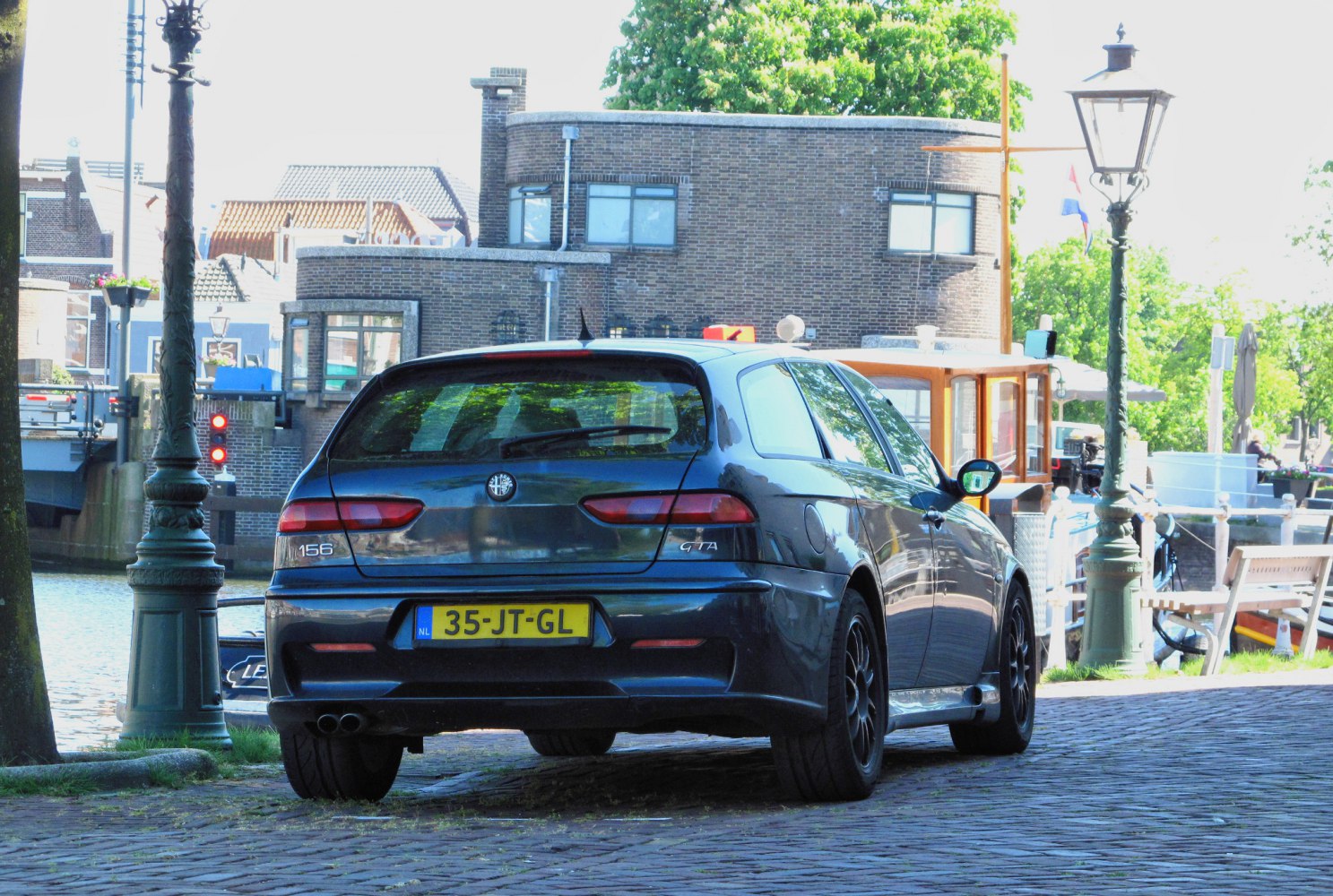 Rear view of a sporty wagon with distinctive taillights and dual exhausts