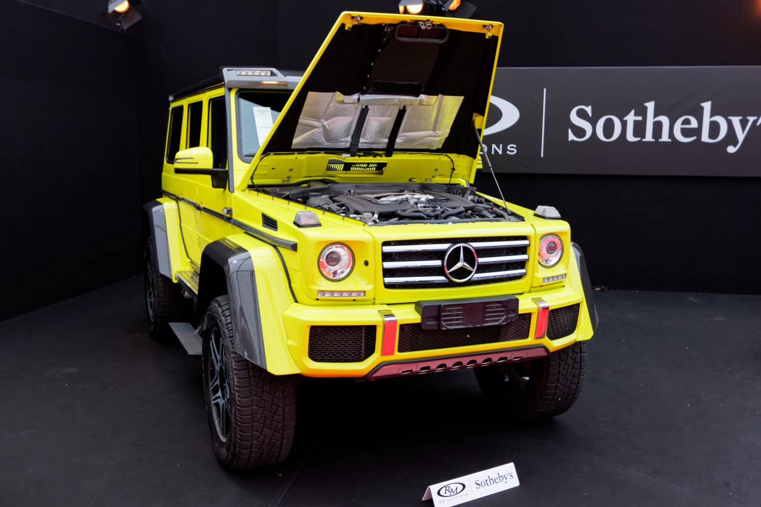 Yellow SUV with open hood showing engine and front design features
