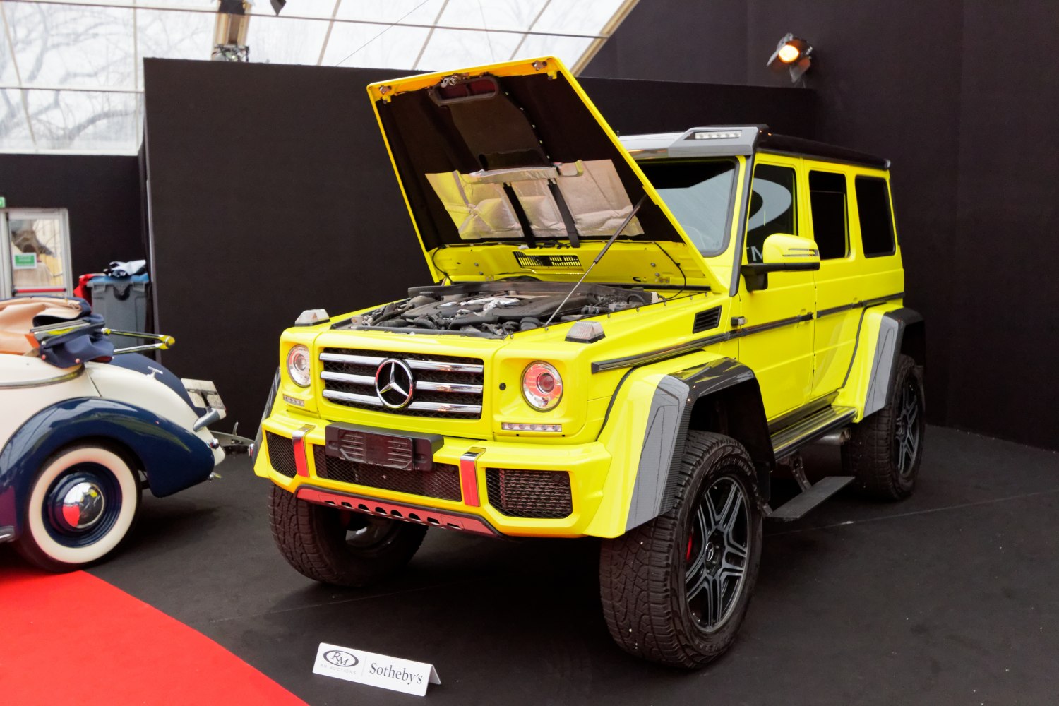 Yellow SUV with open hood showing engine bay and rugged design
