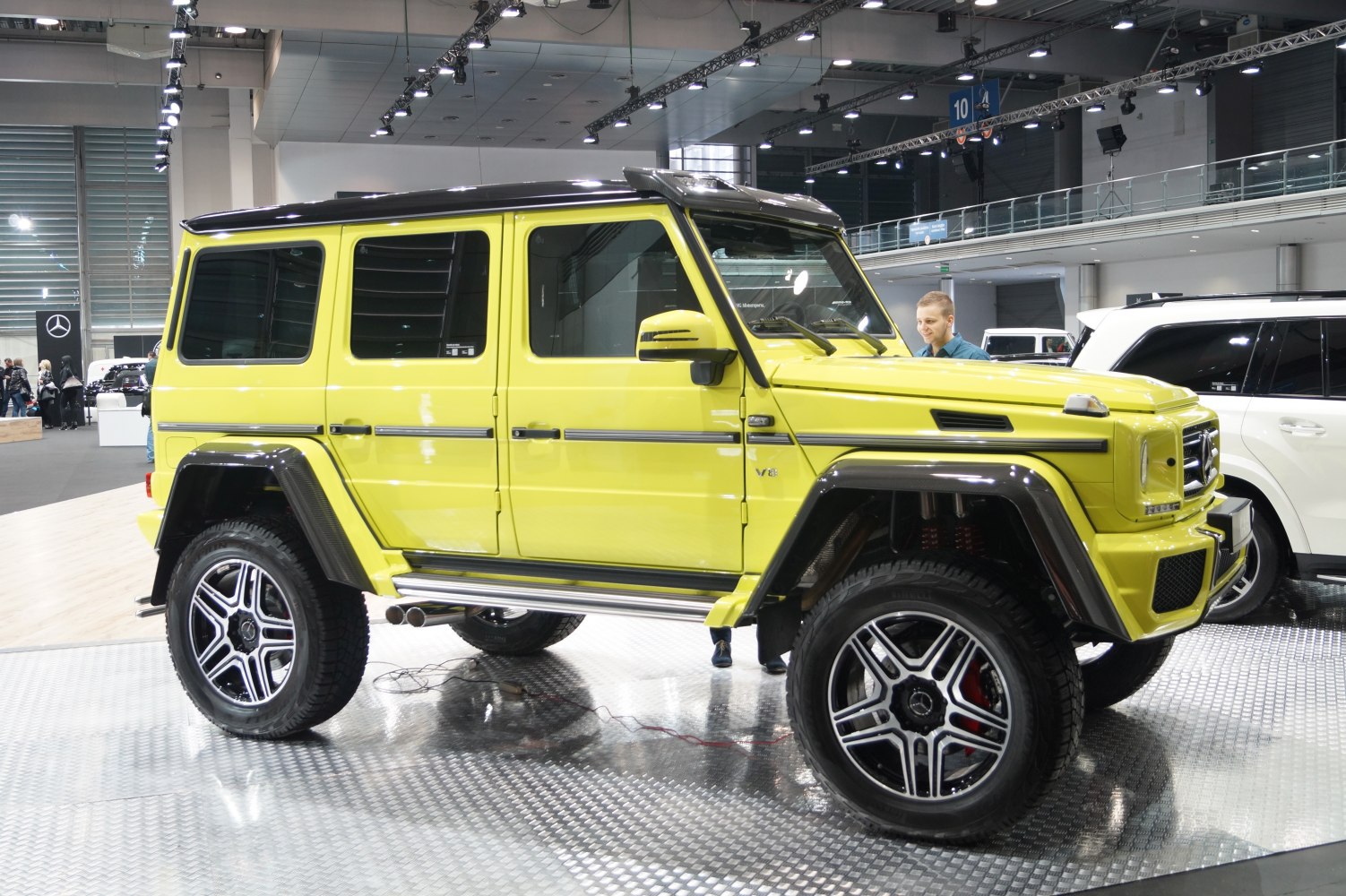 Yellow W463 G-class Long SUV with large off-road wheels and rugged features.
