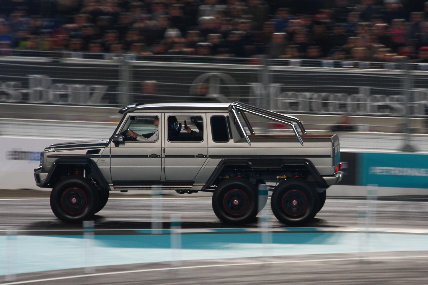 Six-wheel drive luxury pickup with heavy-duty suspension and rugged body