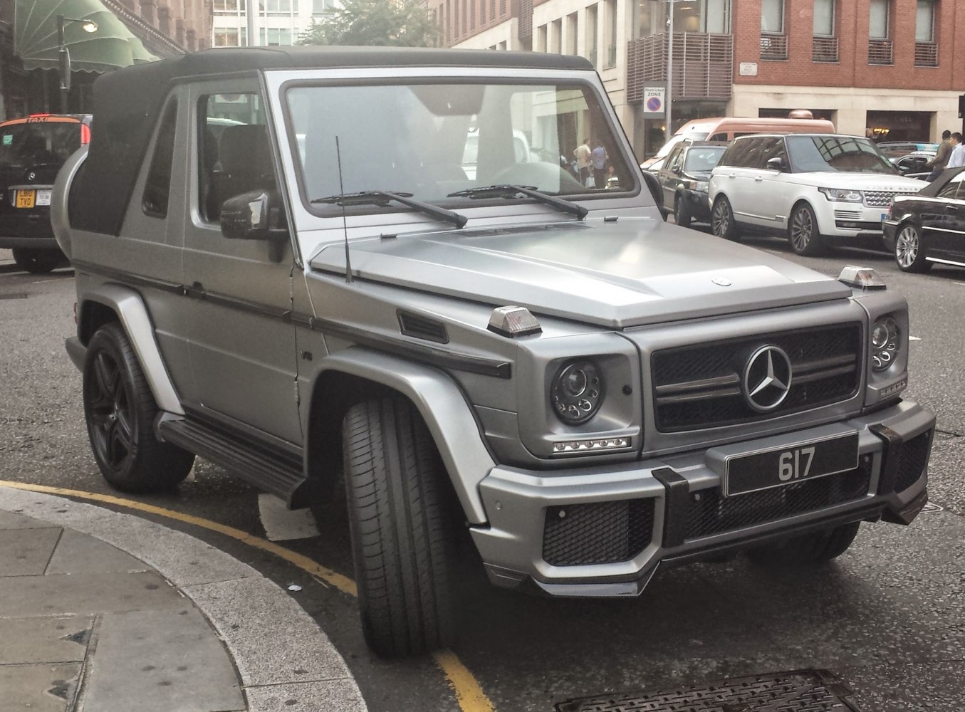 Front view of boxy SUV with soft top and modern headlights