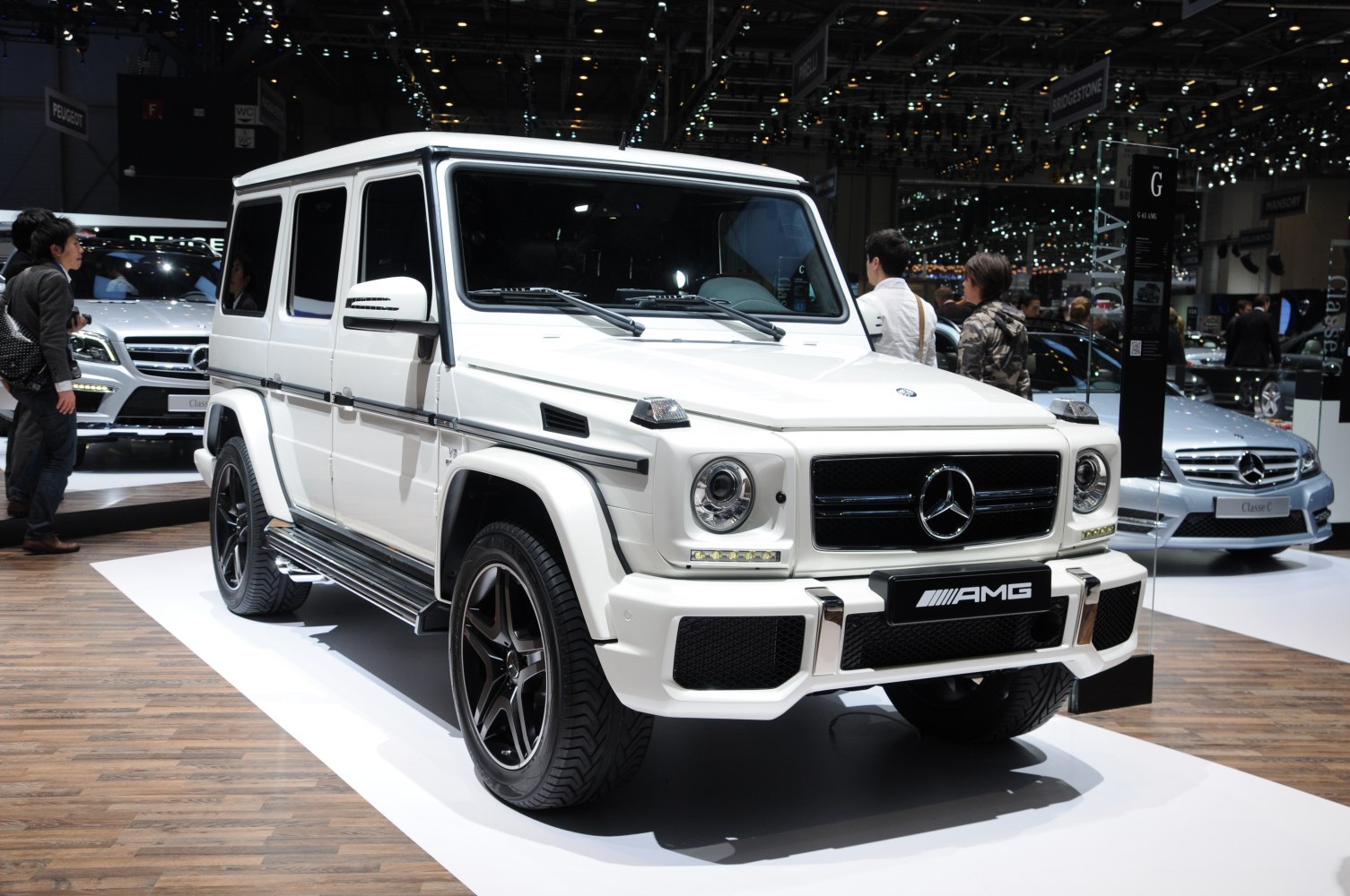 Boxy white SUV with AMG front, long wheelbase, and black rims
