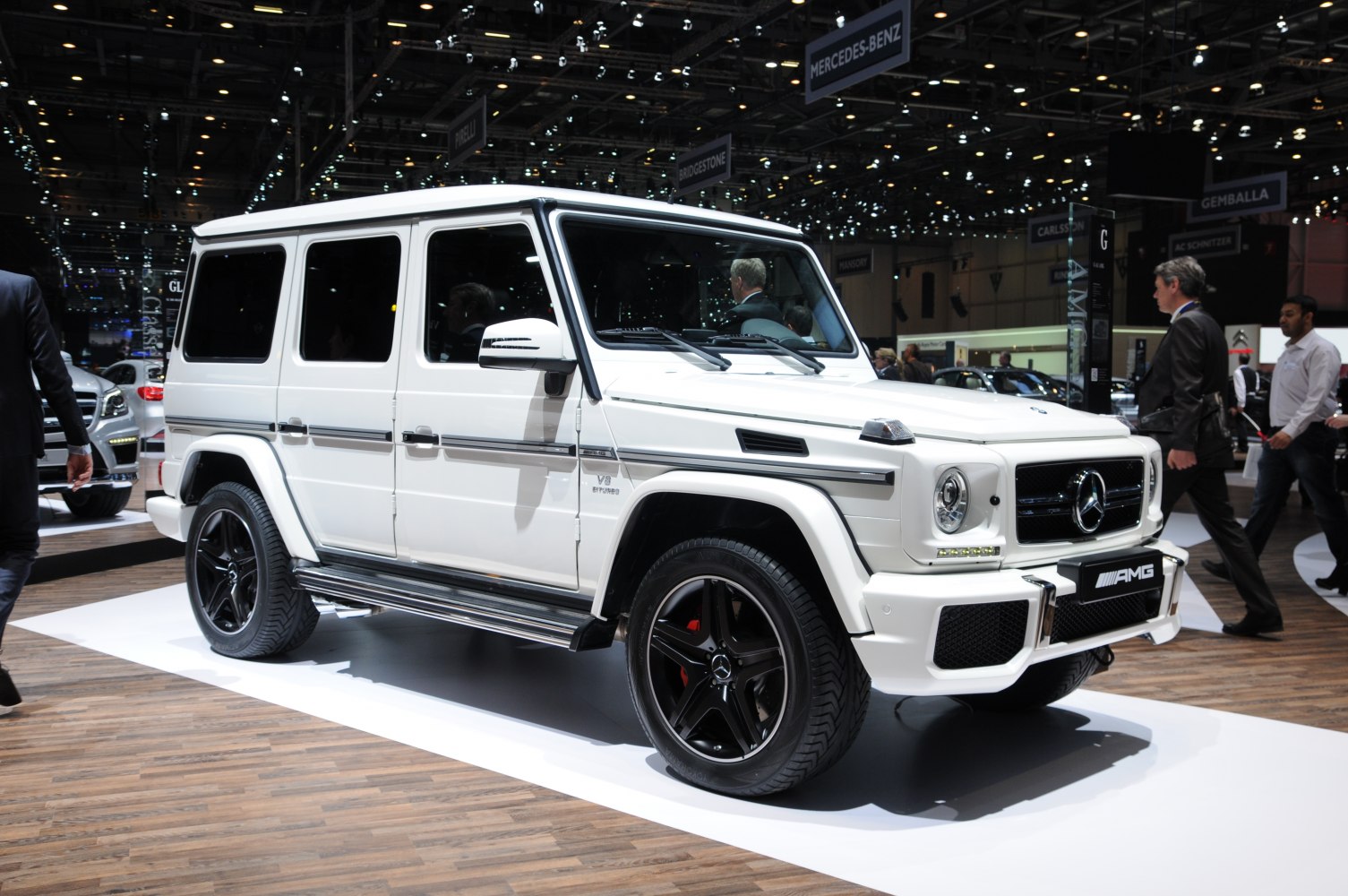 White SUV with AMG styling and black rims on display
