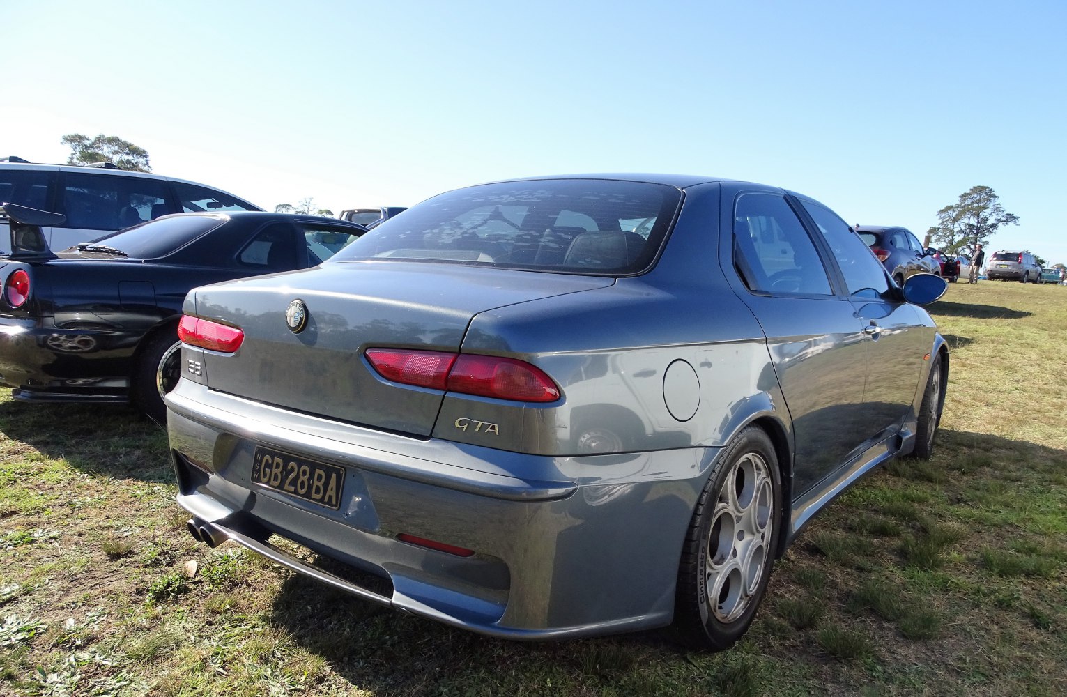 Rear view showing tail lights, sporty bumper, alloy wheels