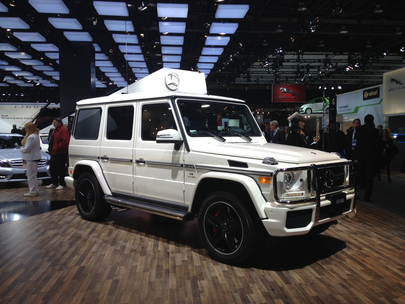 White luxury SUV with side exhaust pipes and black alloy wheels