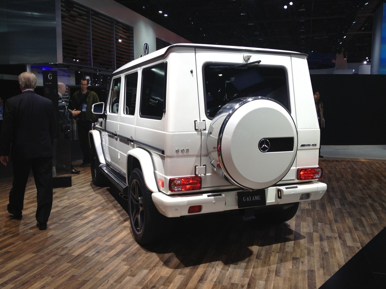 Rear view of white luxury SUV with spare wheel cover and AMG badge