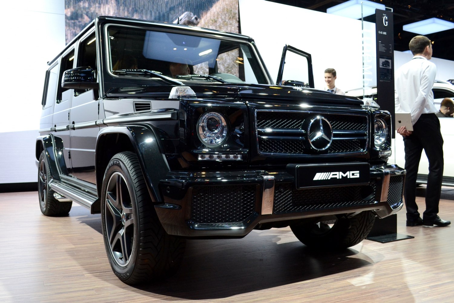 Front angle view of a luxury SUV with round headlights and AMG badge