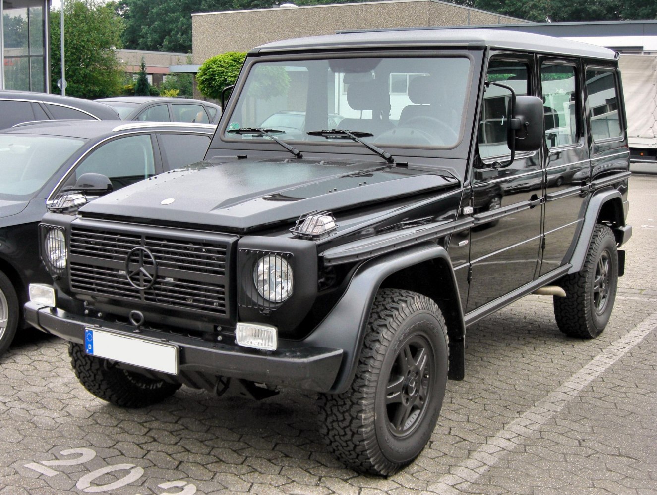 Black SUV with rugged off-road tires and boxy design front view