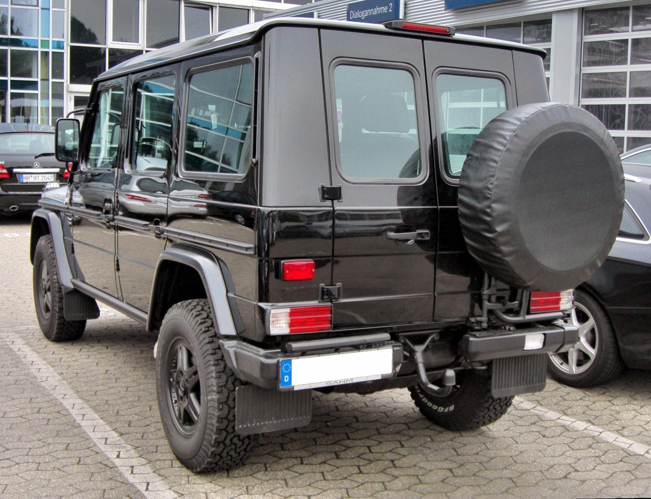 Black SUV rear with spare tire cover and off-road tires