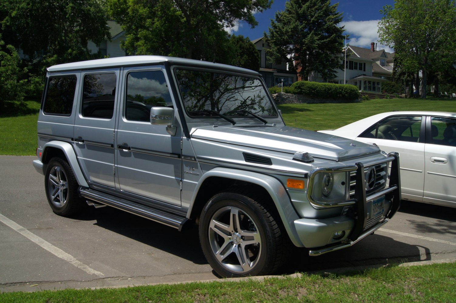 Silver long SUV with front protection bars and five-spoke alloy wheels