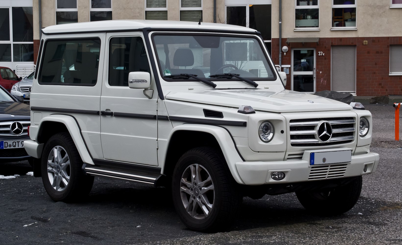 Front three-quarter view of squared SUV with round headlights