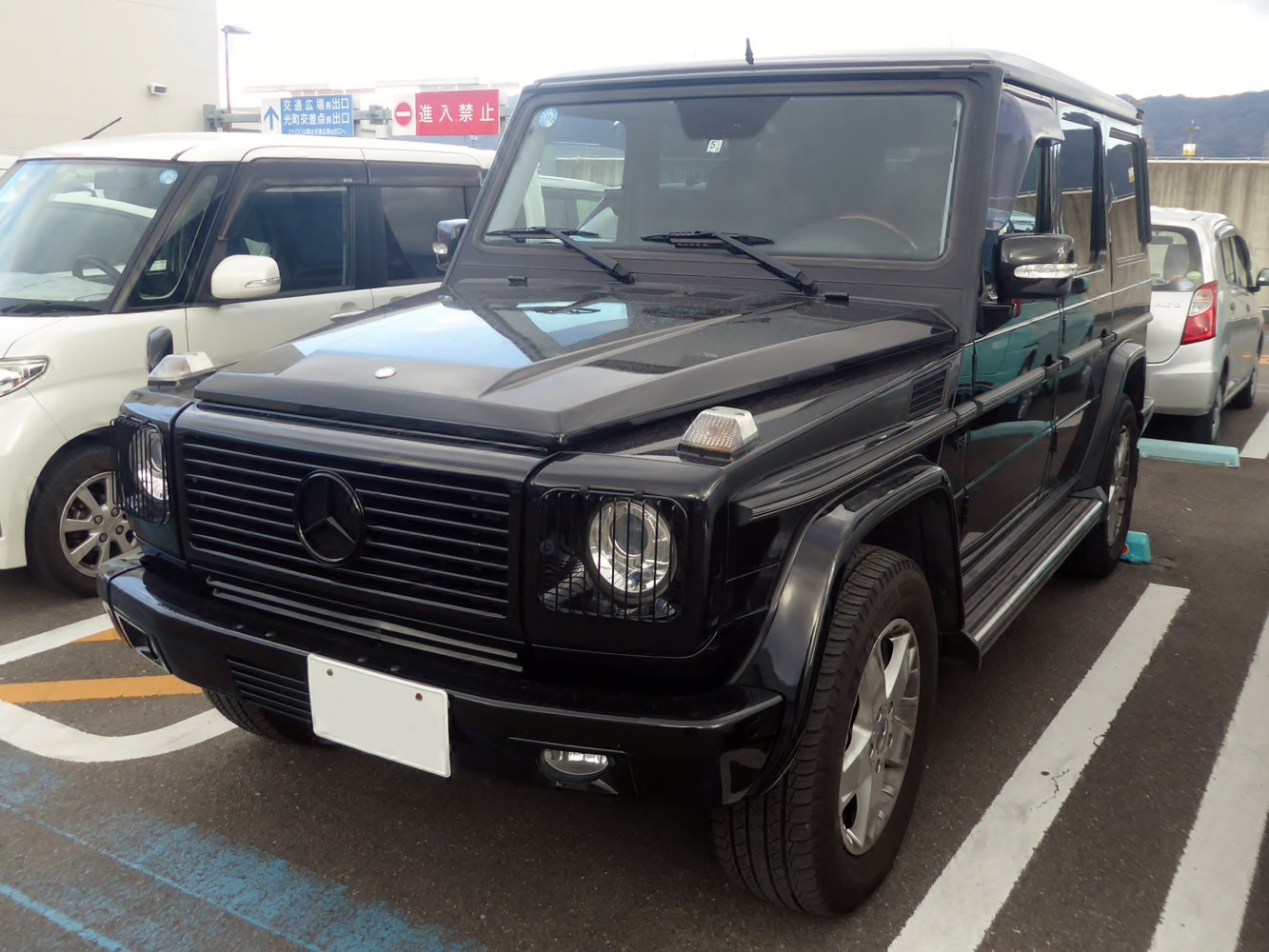Close-up view of front grille and headlights on black SUV.