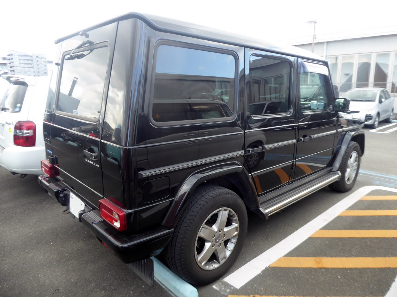 Rear side view of a boxy long-wheelbase SUV with large windows