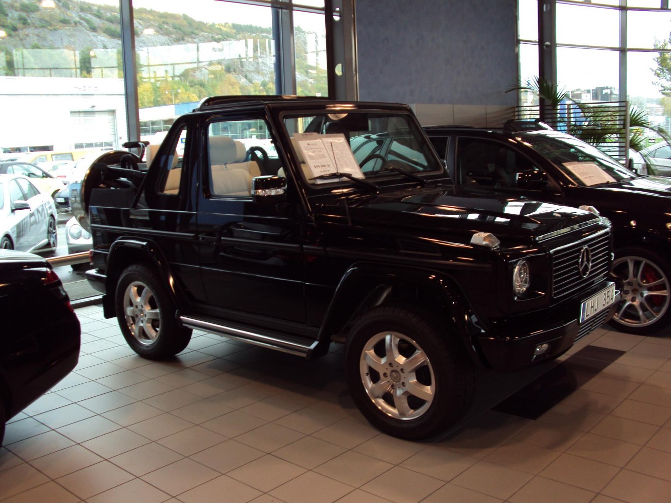Black SUV with soft-top convertible roof and white interior