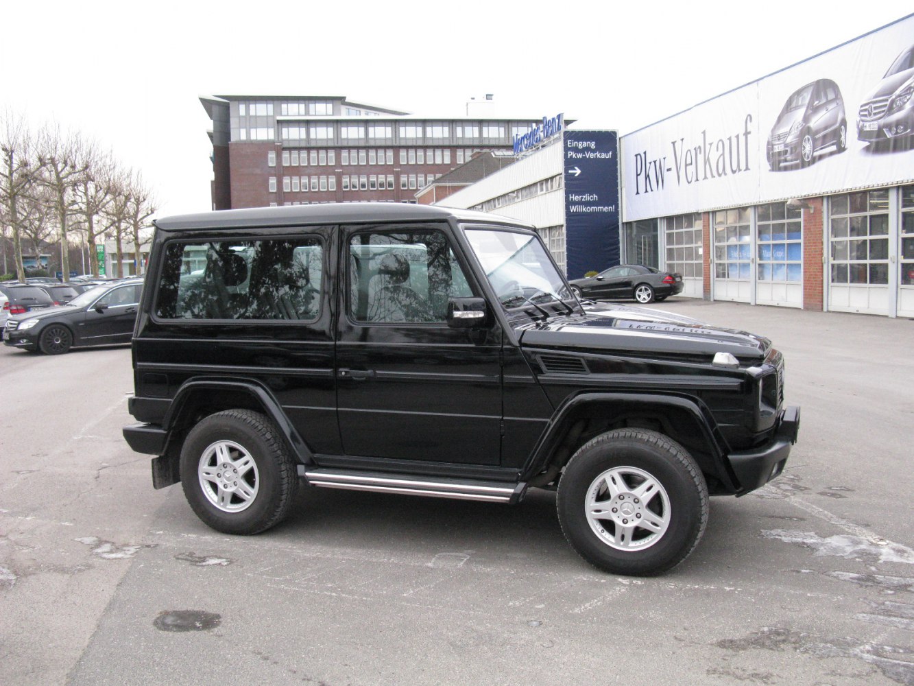 Boxy black SUV side profile with rugged tires and rectangular windows