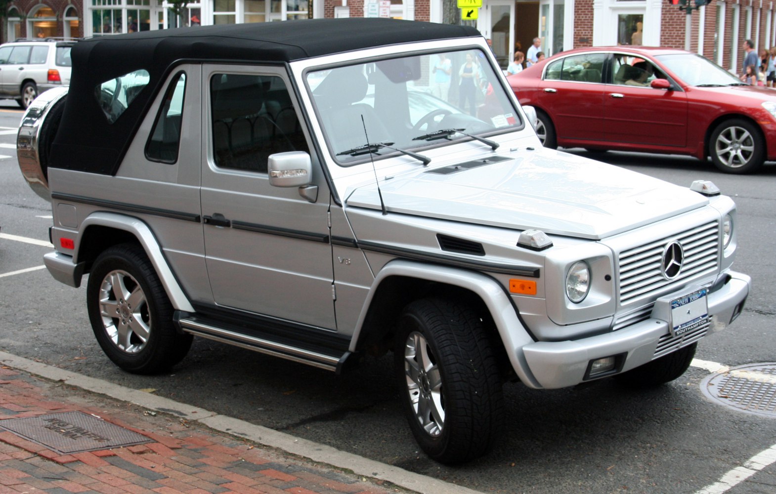 Silver SUV with soft convertible top and rugged design