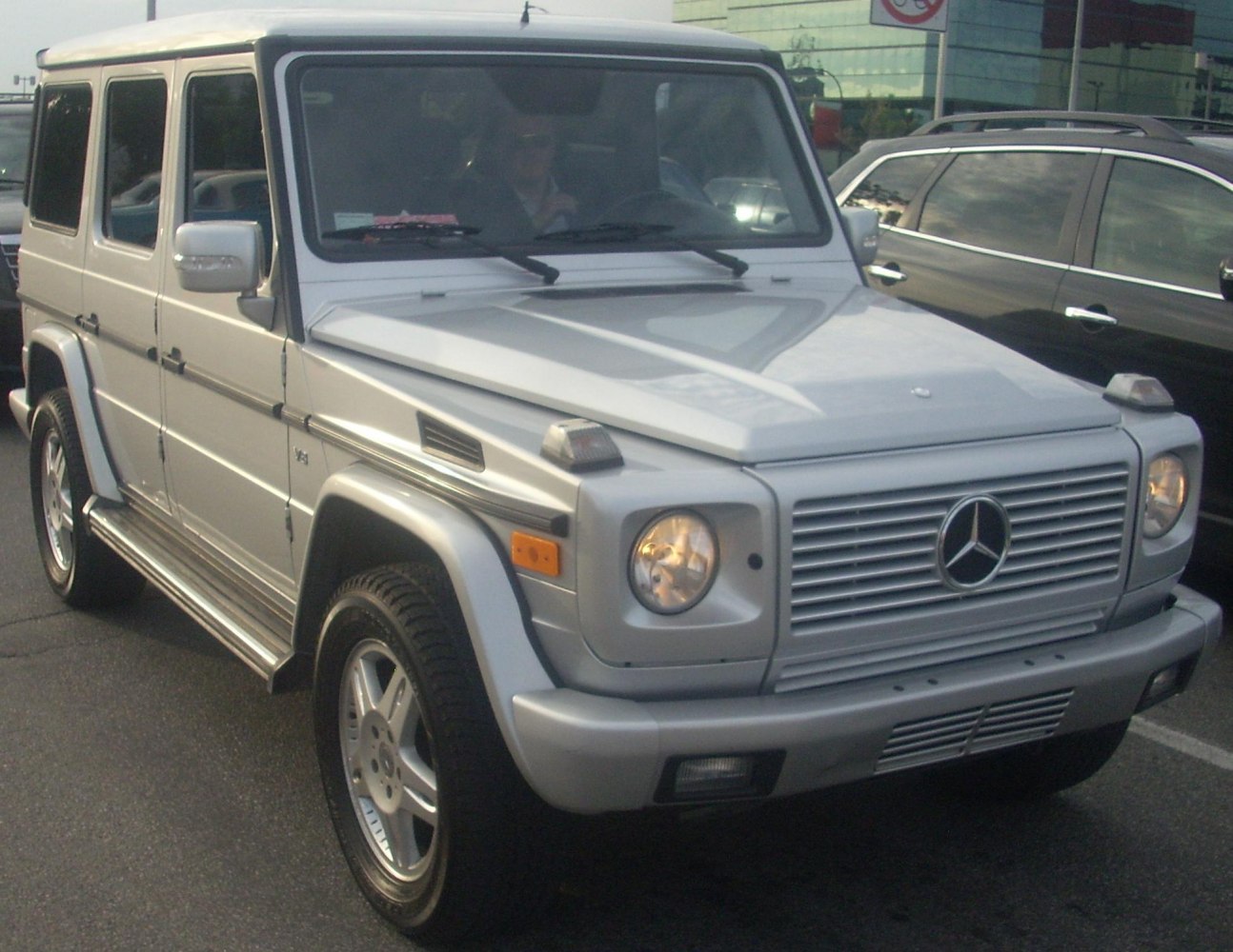Boxy front view of a robust SUV with classic round headlights and distinct grille.