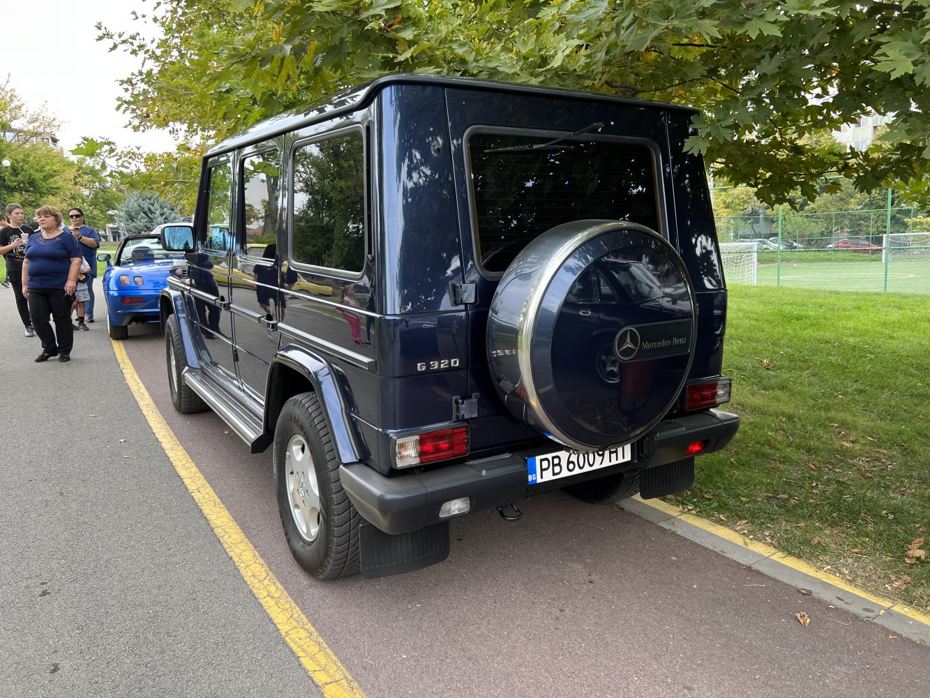 Rear view of a boxy SUV with spare tire cover and rectangular tail lights