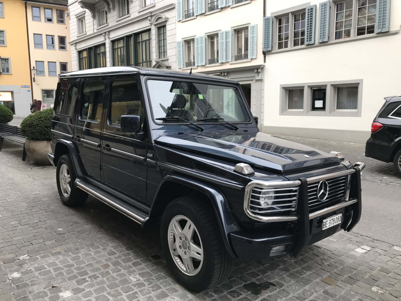 Long-body SUV with front protection bars and chrome side steps