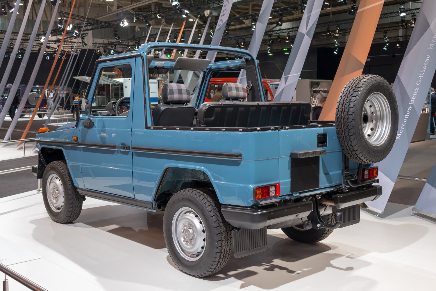 Open-top SUV with rear mounted spare wheel and rugged tires