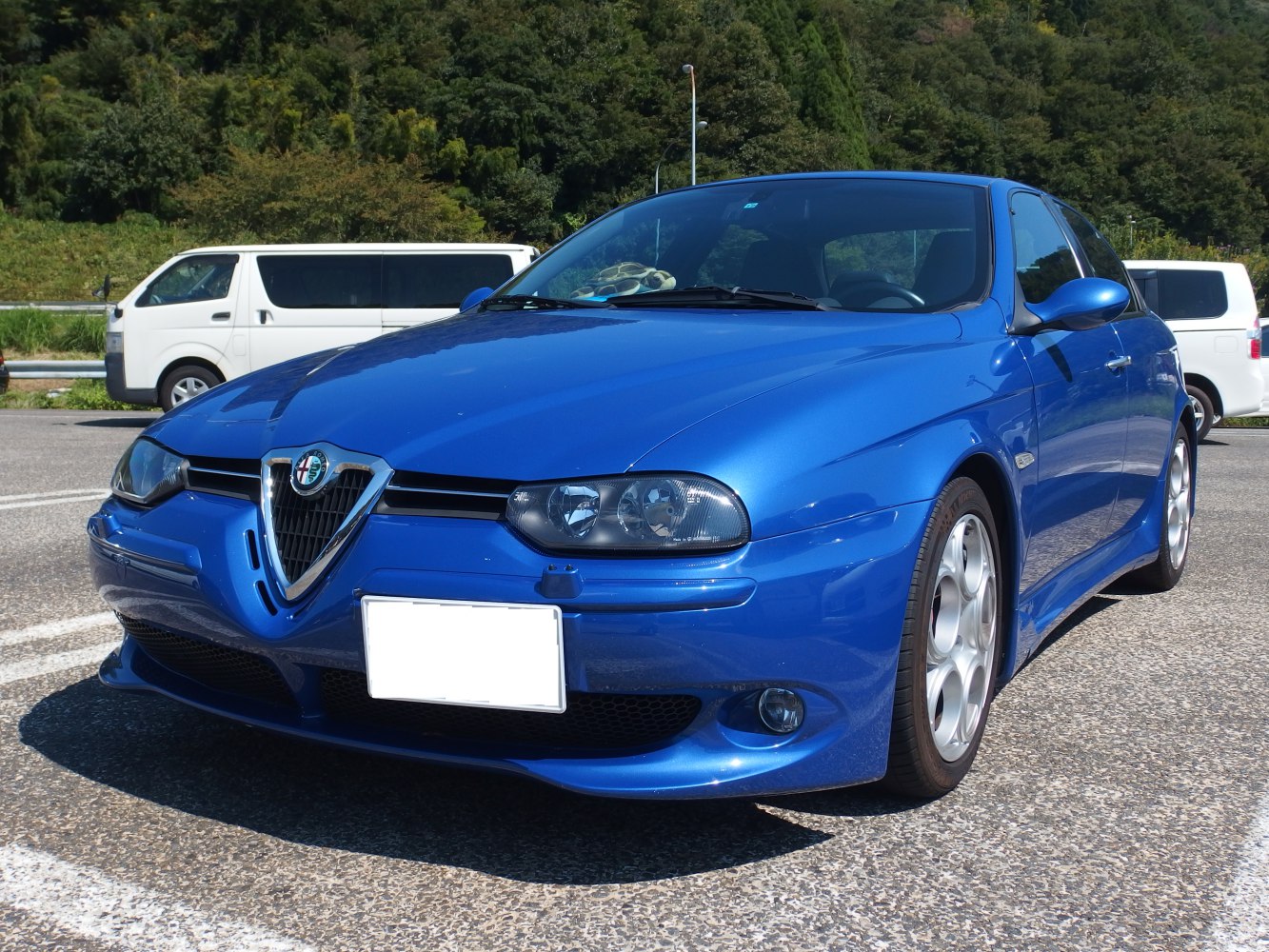 Front and side view of a blue sporty sedan with distinctive grille and alloy wheels.