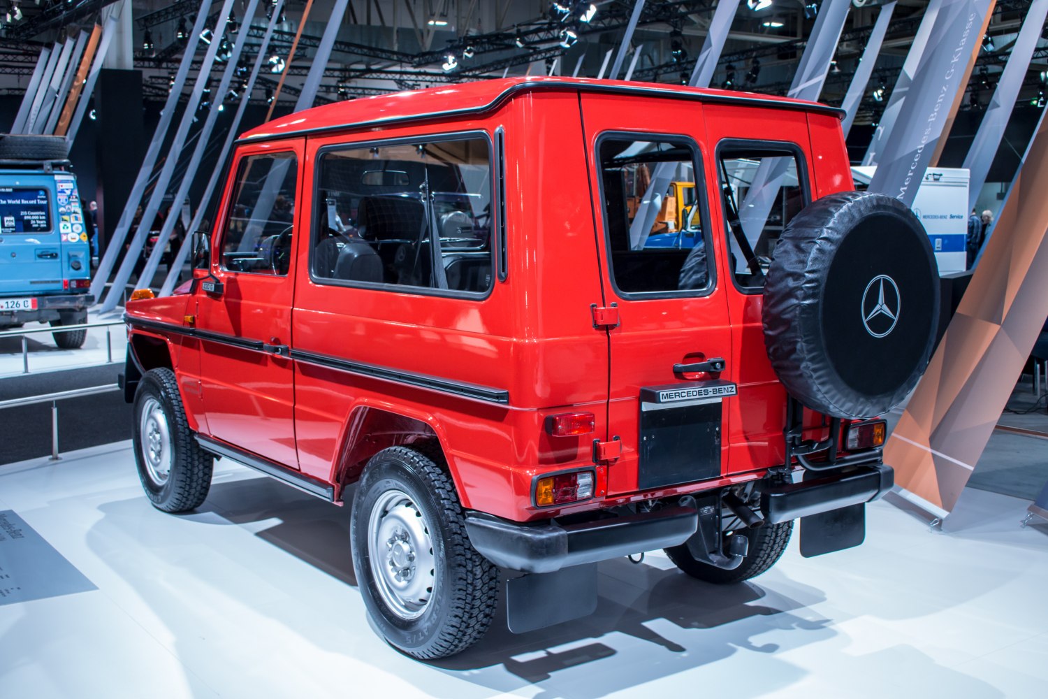 Red off-road SUV with rear spare tire cover and boxy design