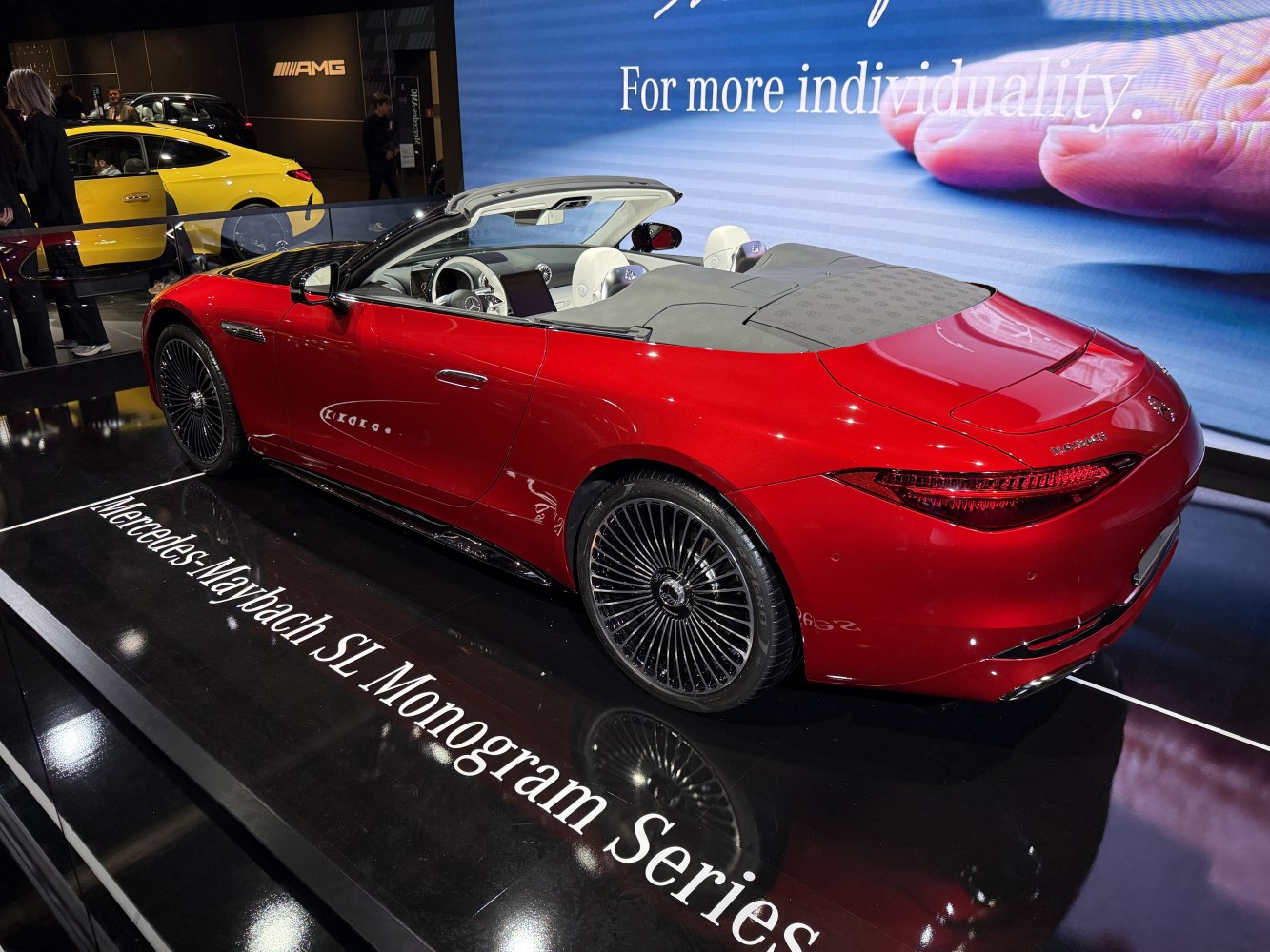Rear and interior view of a luxury convertible roadster in red.