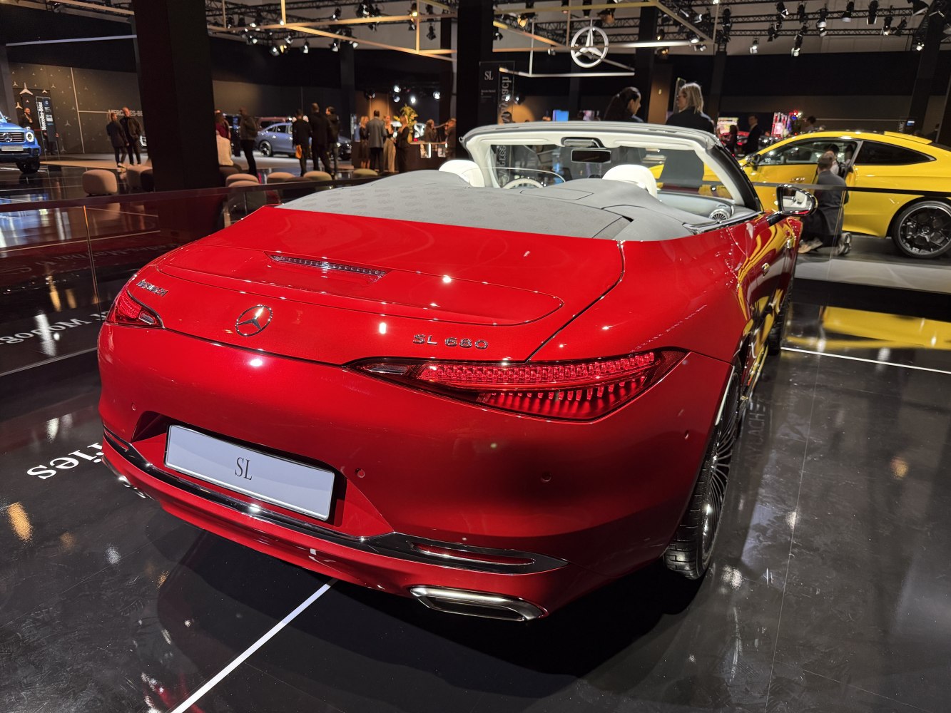 Rear of a red convertible with sleek taillights and dual exhausts