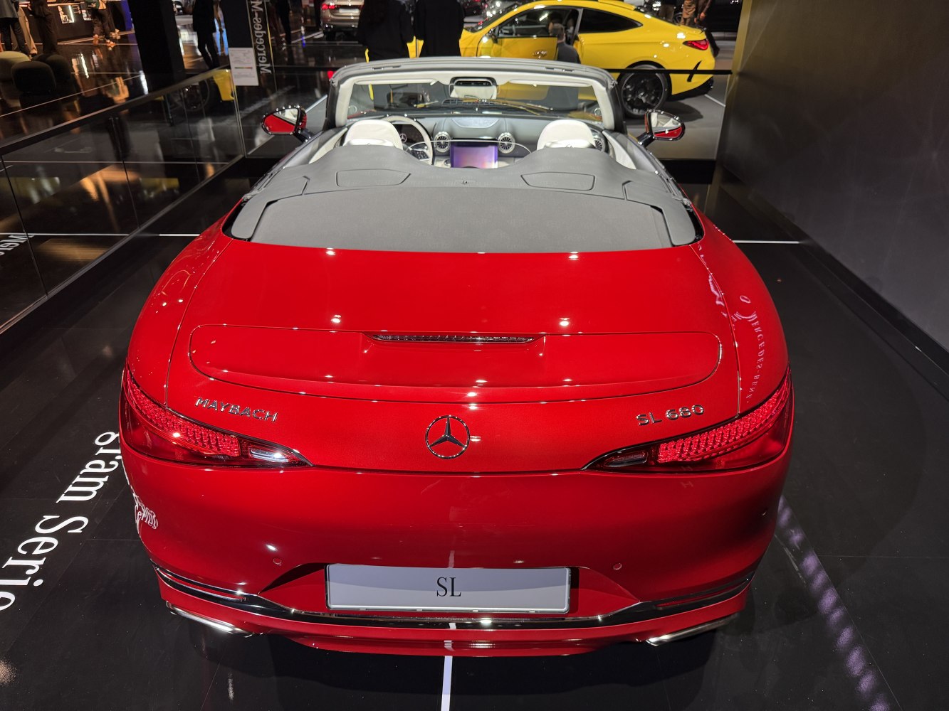 Rear view of a red luxury convertible with detailed taillights and badge