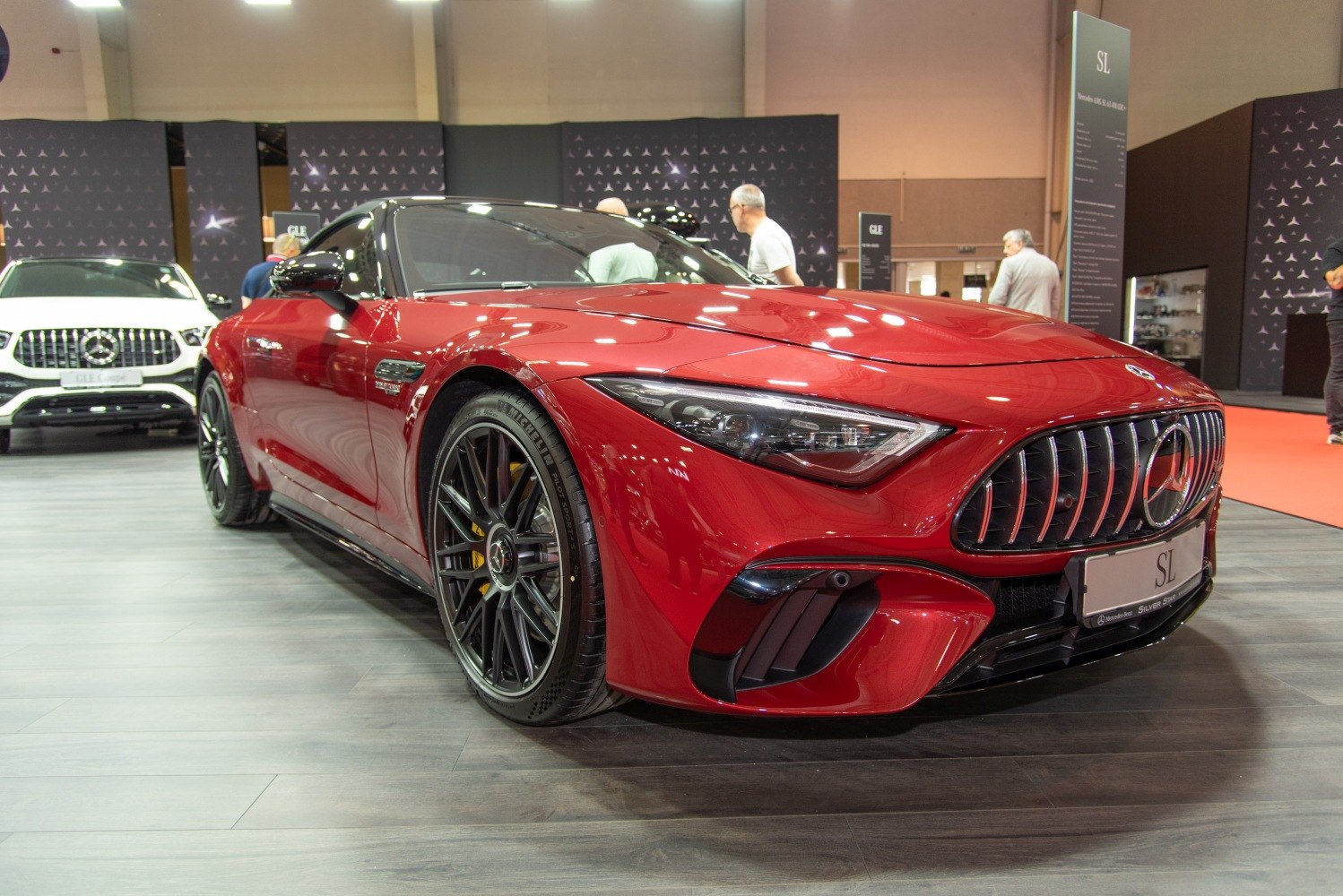 Red sports coupe with aggressive front grille and sharp angular headlights