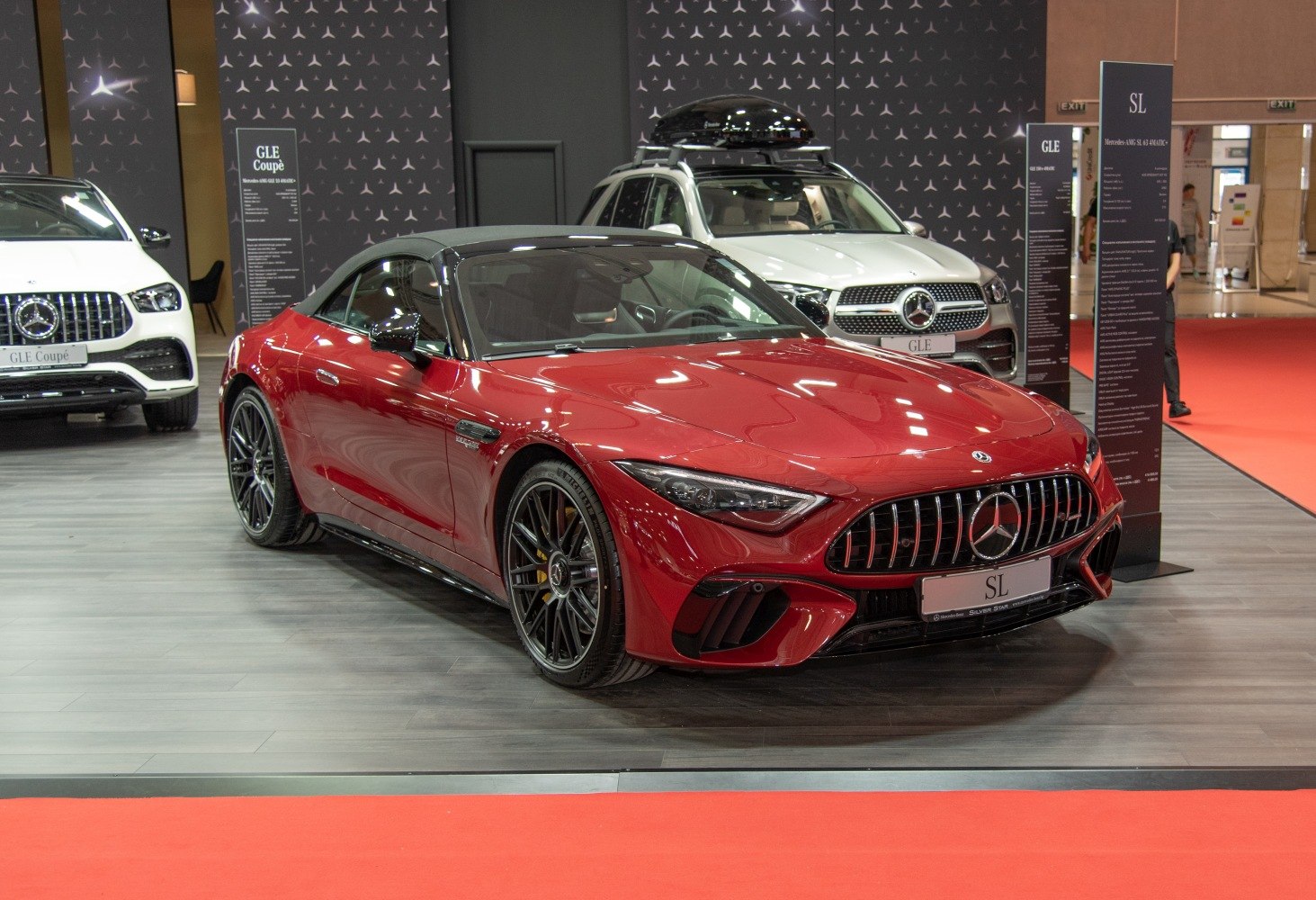 Red luxury convertible with aggressive front grille and aerodynamic design