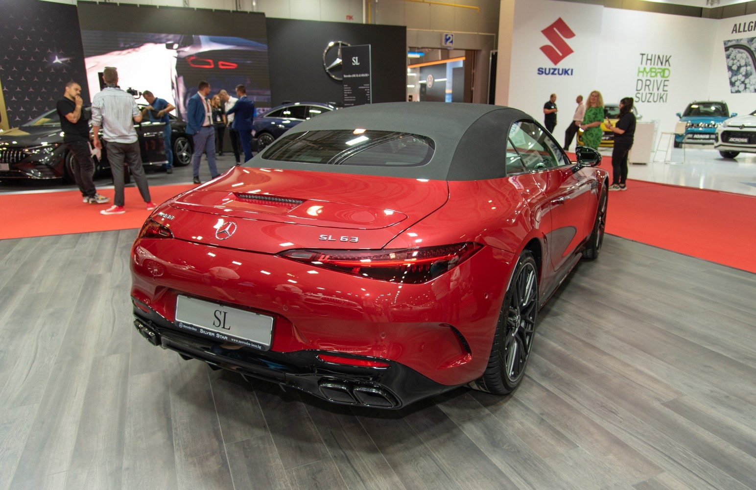 Rear view of convertible roadster with sleek taillights and quad exhaust.