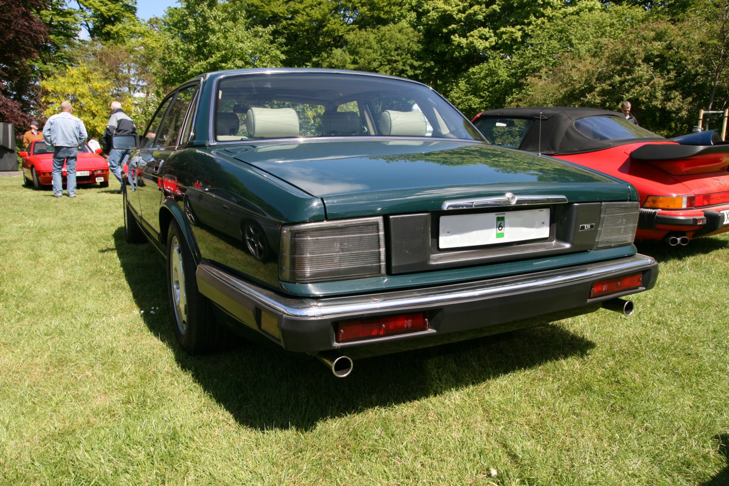 Rear view of vintage sedan with tinted tail lights and dual exhaust pipes