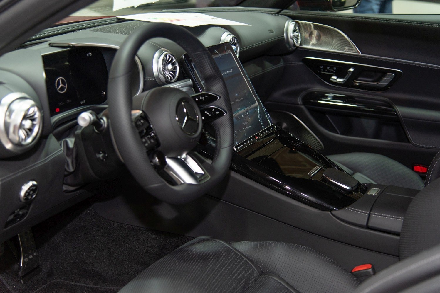 Luxury car interior with digital dashboard and vertical touchscreen console