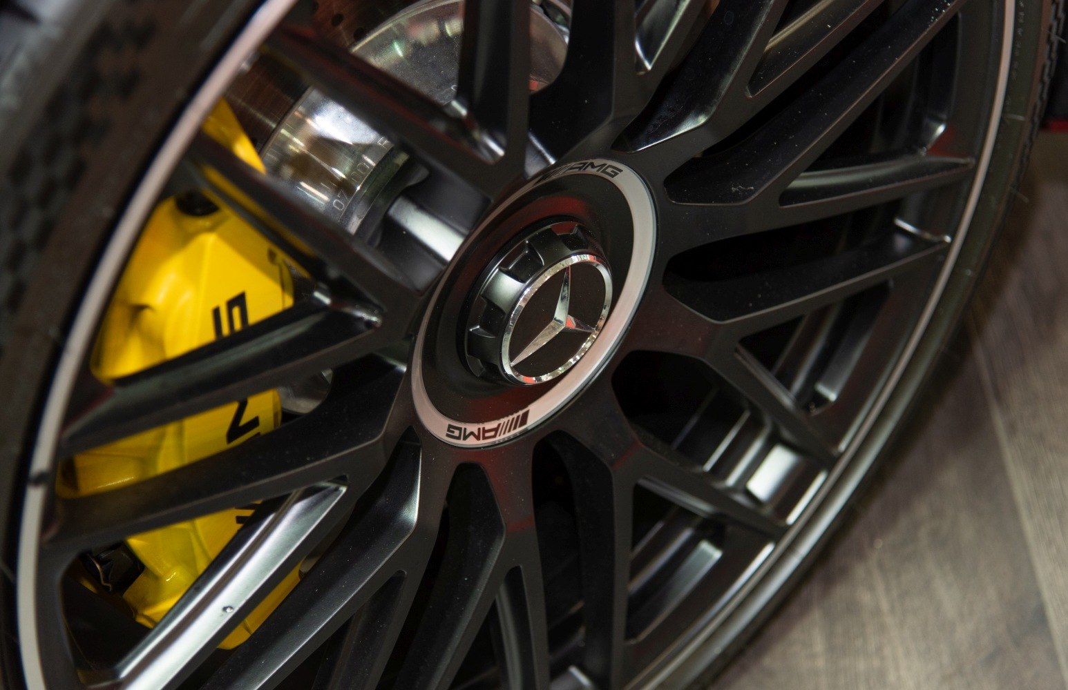 Black multi-spoke AMG wheel with yellow brake caliper