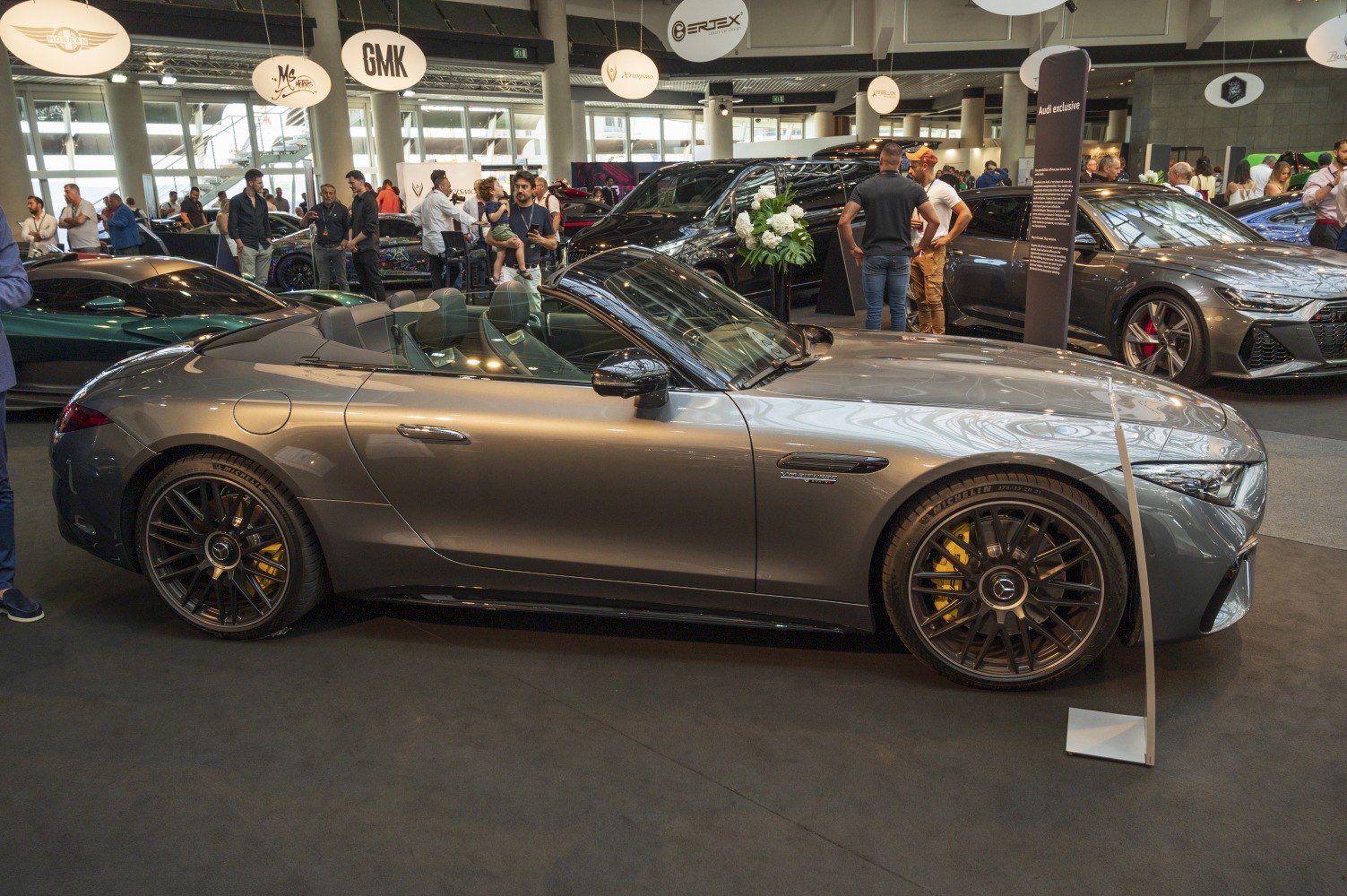 Side profile of a convertible coupe with black alloy wheels and yellow brake calipers