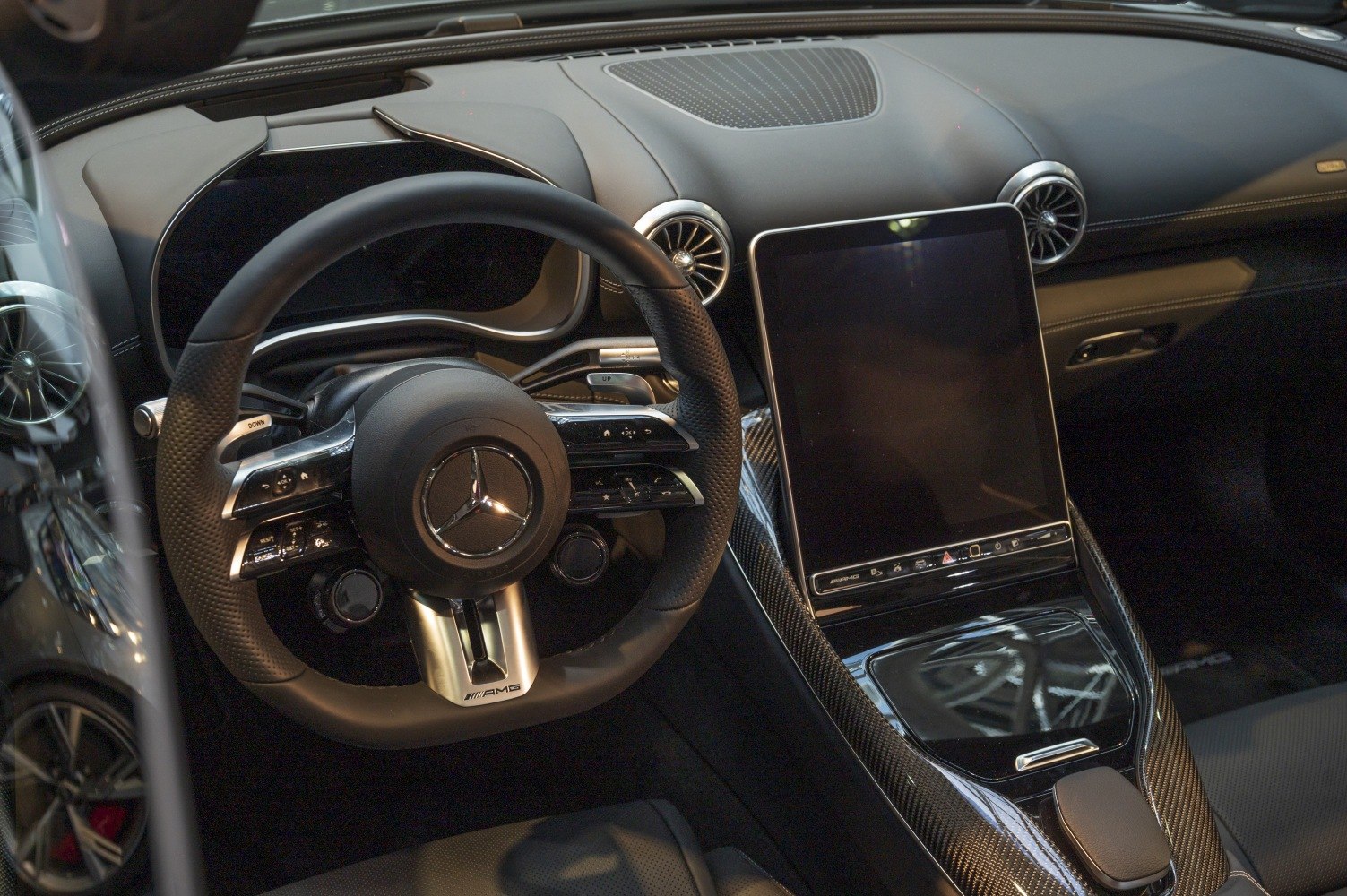AMG steering wheel and carbon fiber console with large infotainment screen