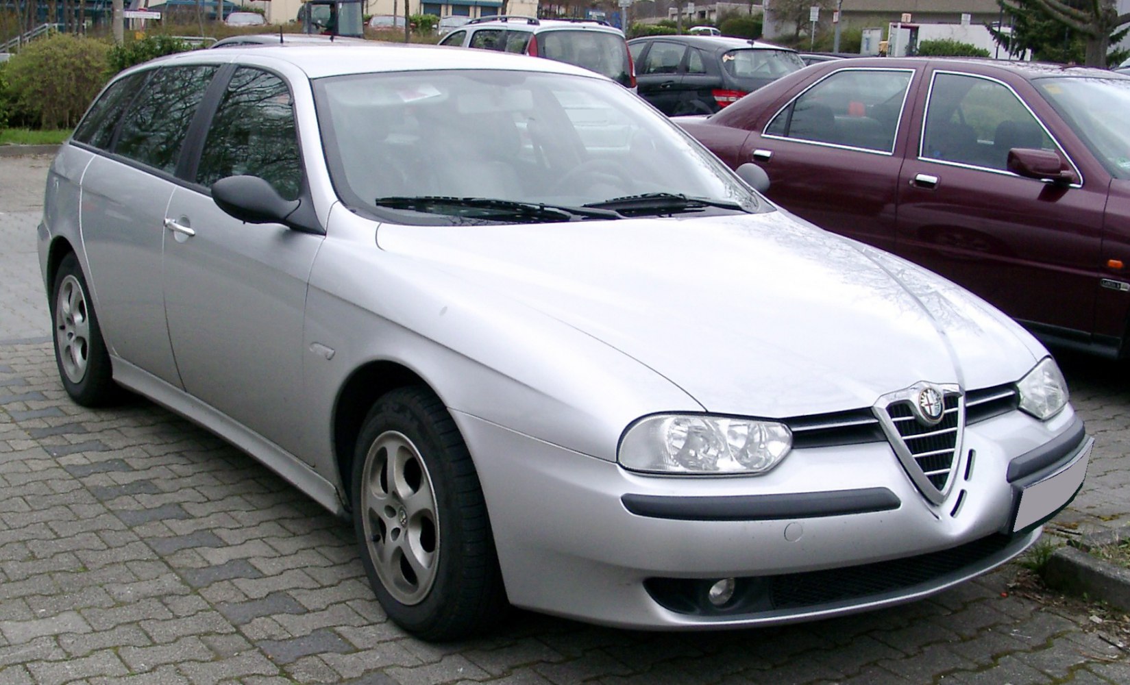 Front side view with distinctive headlights and triangular grille
