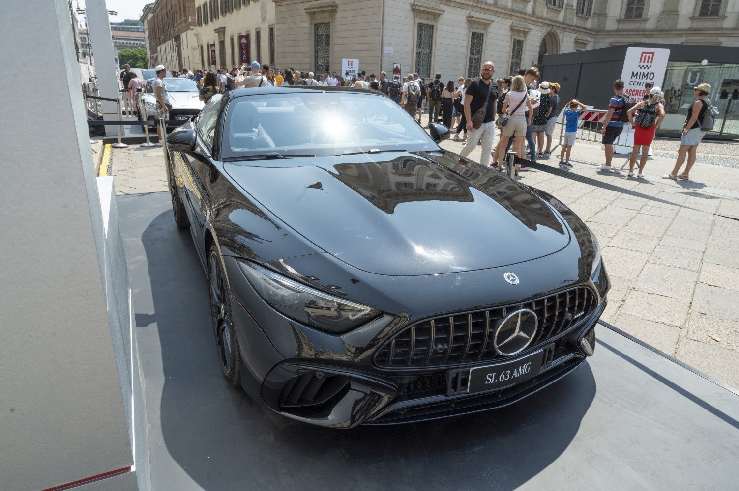 Front view of black sports coupe with aggressive grille and sharp headlights.